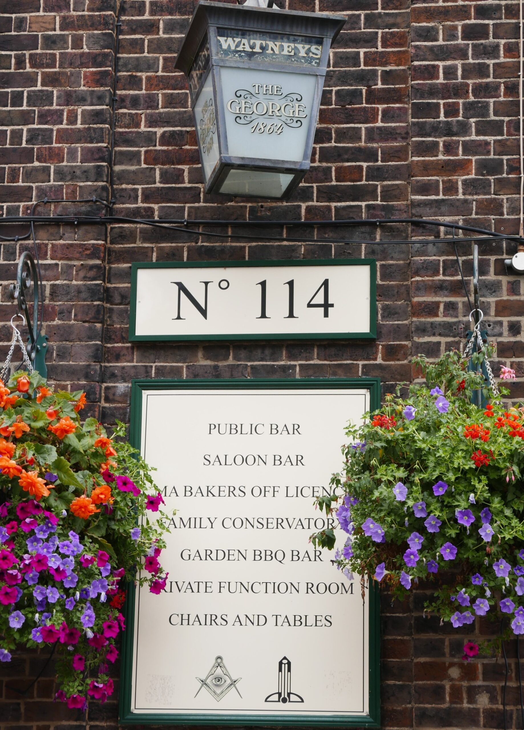 Square and Compasses on a pub sign at The George.