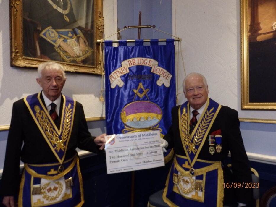 W. Bro Peter Gledhill PGStdB (R) from the MMC handing a cheque to W Bro Alan Winter PGStdB (L) the Charity Steward of Putney Bridge Lodge.