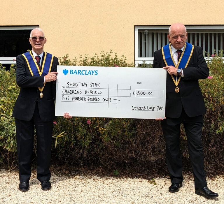 L-R: W. Bro Richard Cannon and W. Bro Mick Pullin with donation for Shooting Star Children's Hospices.
