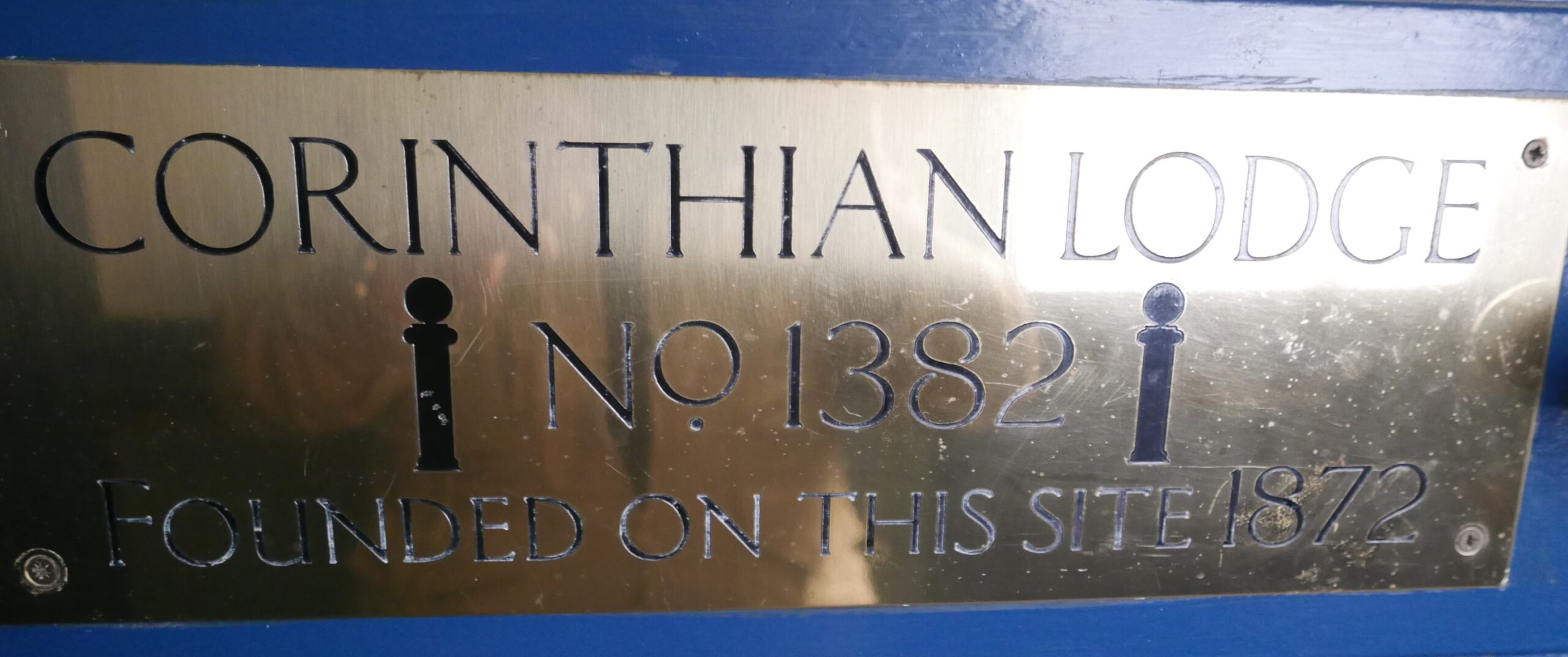 Brass plaque commemorating the meeting place of Corinthian Lodge No 1382 in the cellar of The George Public House.